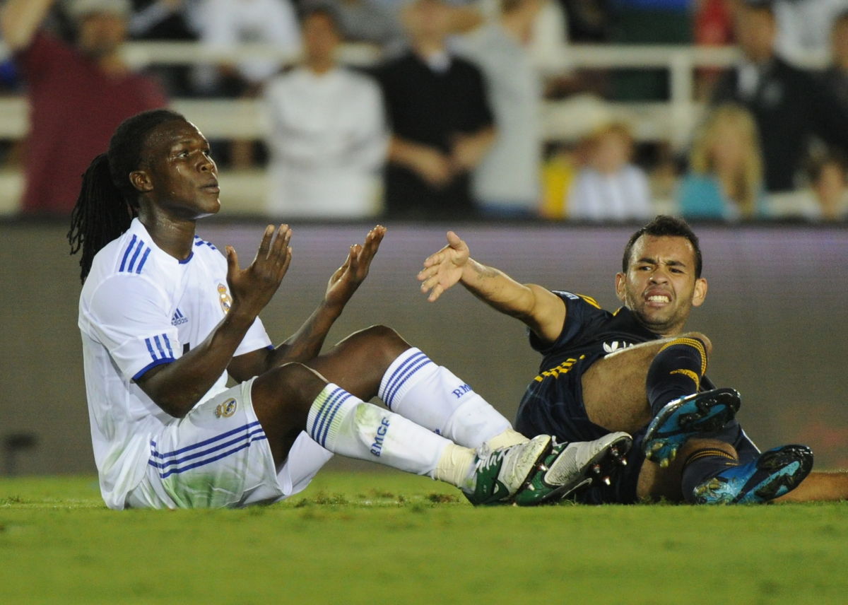 Real Madrid defender Royston Ricky Drenthe (L) pleads his innocence as LA Galaxy player Juninho (R) appeals and gets a penalty during their friendly at the Rose Bowl in Pasadena, California on August 7, 2010.  Real Madrid went on to win 3-2.        AFP PHOTO/Mark RALSTON (Photo credit should read MARK RALSTON/AFP/Getty Images)