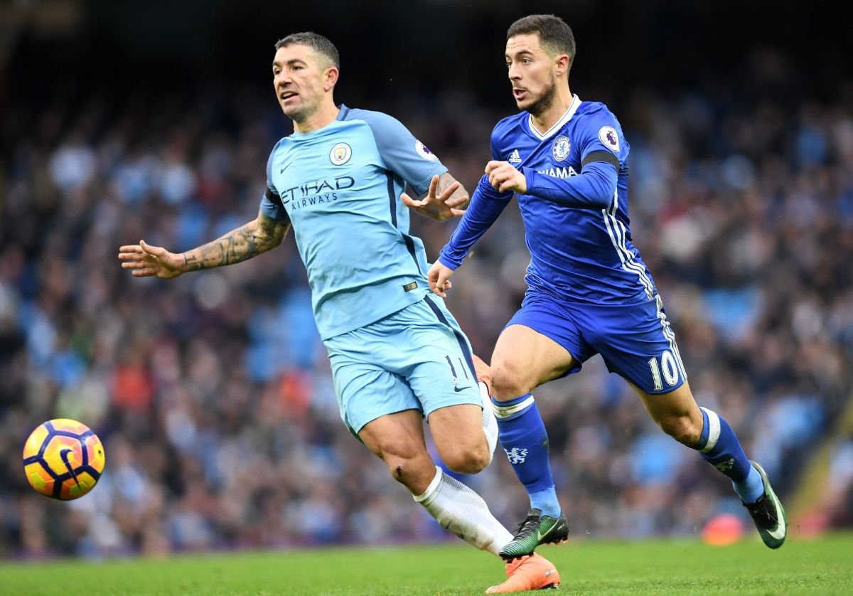 Chelsea's Belgian midfielder Eden Hazard (R) breaks away from Manchester City's Serbian defender Aleksandar Kolarov to scores his team's thrid goal during the English Premier League football match between Manchester City and Chelsea at the Etihad Stadium in Manchester, north west England, on December 3, 2016. / AFP / Paul ELLIS / RESTRICTED TO EDITORIAL USE. No use with unauthorized audio, video, data, fixture lists, club/league logos or 'live' services. Online in-match use limited to 75 images, no video emulation. No use in betting, games or single club/league/player publications.  /         (Photo credit should read PAUL ELLIS/AFP/Getty Images)