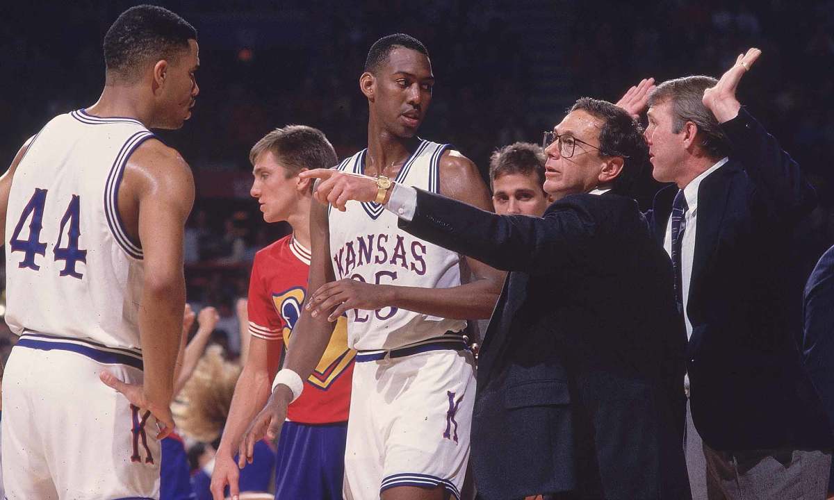 A young Gregg Popovich (far right) dishes advice to Kansas star Danny Manning.