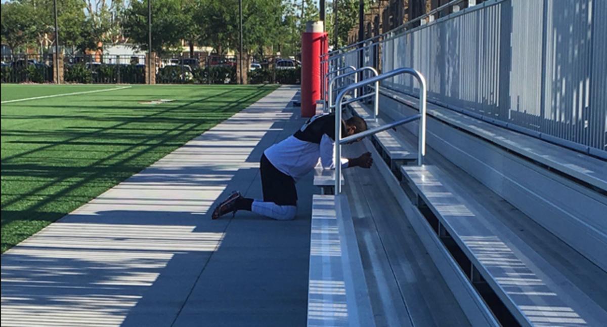 Andre Lewis prays before practice.