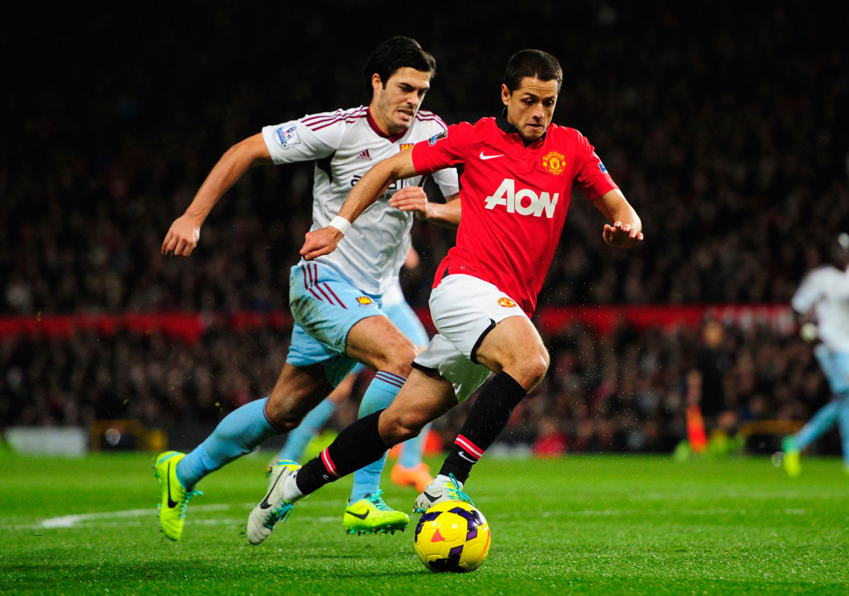 MANCHESTER, ENGLAND - DECEMBER 21:  Javier Hernandez of Manchester United competes with James Tomkins of West Ham United during the Barclays Premier League match between Manchester United and West Ham United at Old Trafford on December 21, 2013 in Manchester, England.  (Photo by Stu Forster/Getty Images)