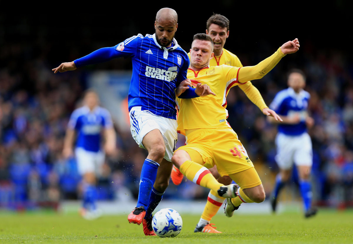 IPSWICH, ENGLAND - APRIL 30:  David McGoldrick of Ipswich Town and Kevin Long of MK Dons compete for the ball during the Sky Bet Championship match between Ipswich Town and Milton Keynes Dons at Portman Road on April 30, 2016 in Ipswich, England. (Photo by Stephen Pond/Getty Images)