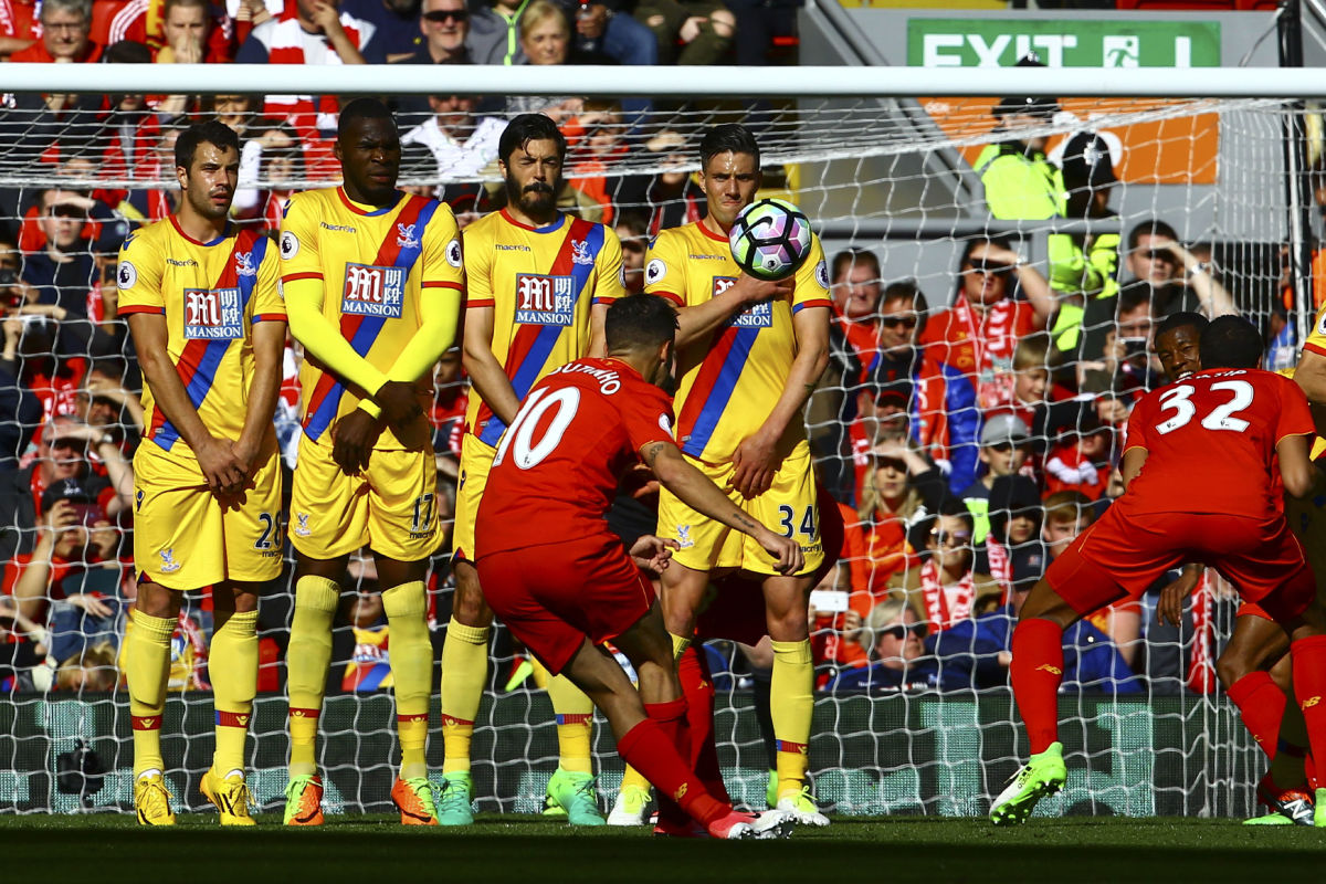 Liverpool's Brazilian midfielder Philippe Coutinho (C) scores during the English Premier League football match between Liverpool and Crystal Palace at Anfield in Liverpool, north west England on April 23, 2017. / AFP PHOTO / Geoff CADDICK / RESTRICTED TO EDITORIAL USE. No use with unauthorized audio, video, data, fixture lists, club/league logos or 'live' services. Online in-match use limited to 75 images, no video emulation. No use in betting, games or single club/league/player publications.  /         (Photo credit should read GEOFF CADDICK/AFP/Getty Images)