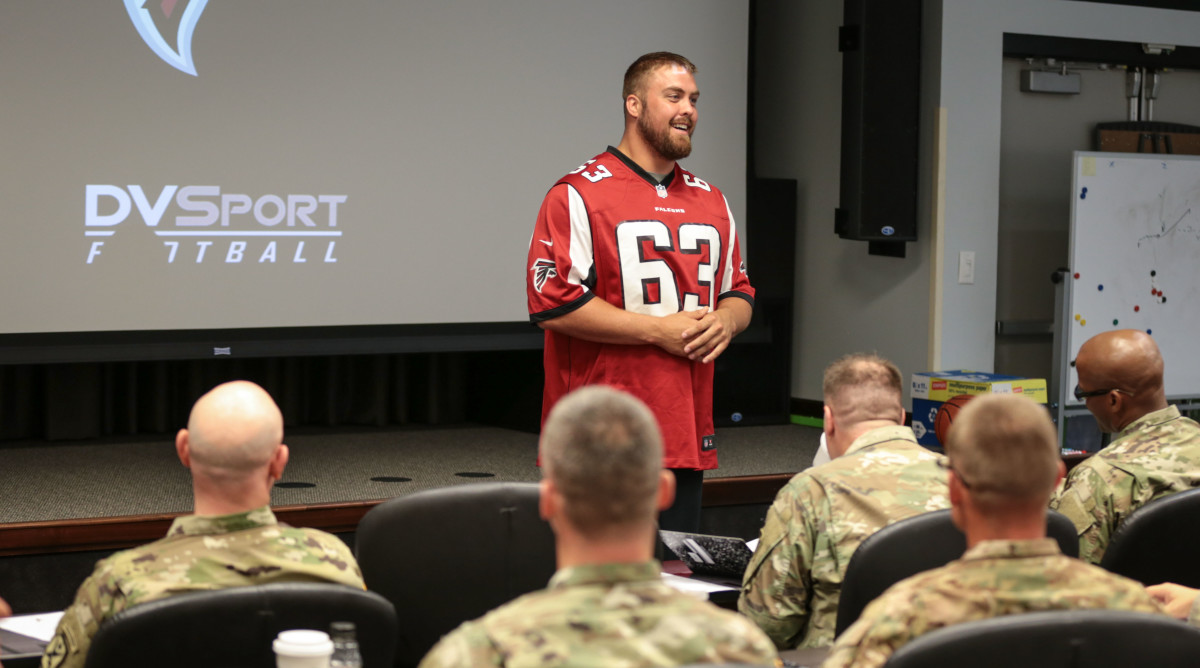 Falcons guard Ben Garland speaks to military servicemen. 