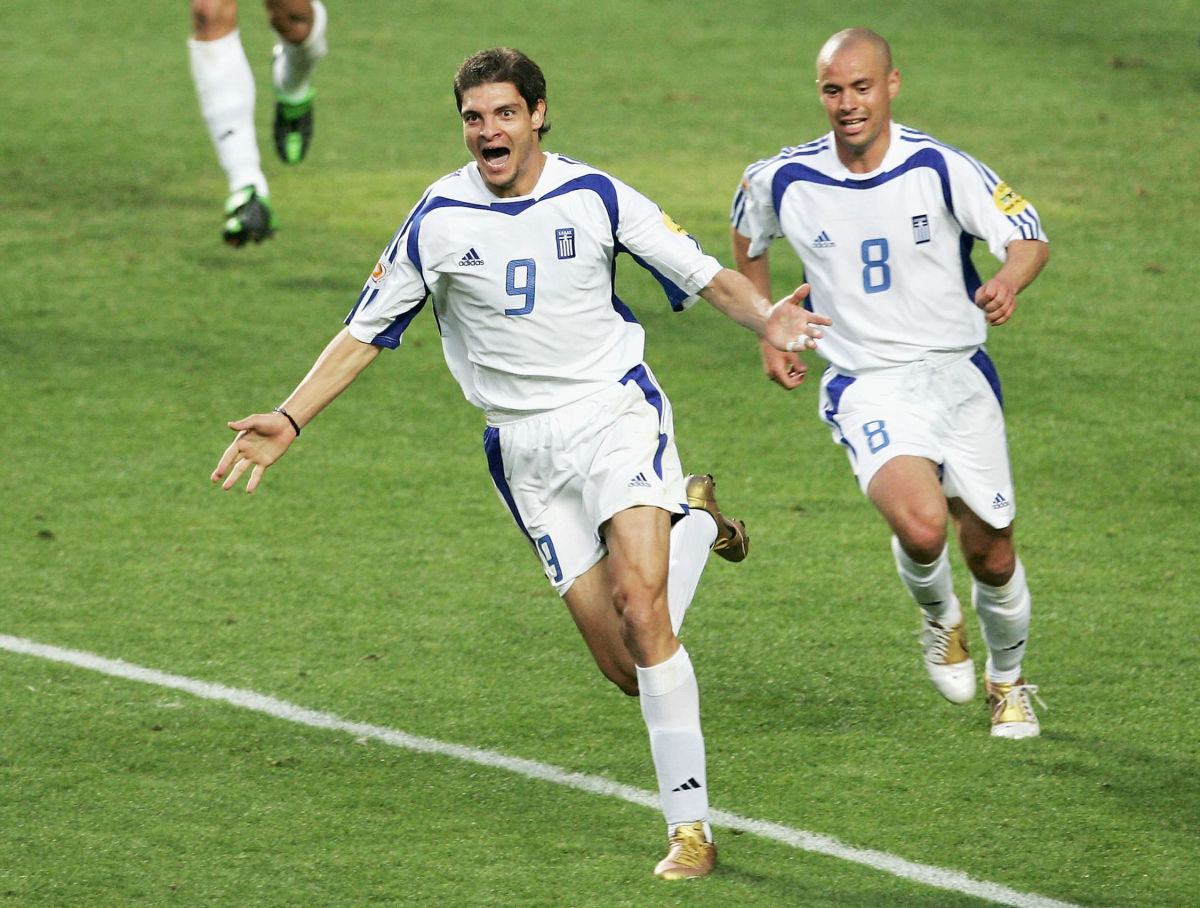 LISBON, PORTUGAL - JULY 4:  Angelos Charisteas of Greece celebrates scoring their first goal during the UEFA Euro 2004 Final match between Portugal and Greece at the Luz Stadium on July 4, 2004 in Lisbon, Portugal. (Photo by Laurence Griffiths/Getty Images)
