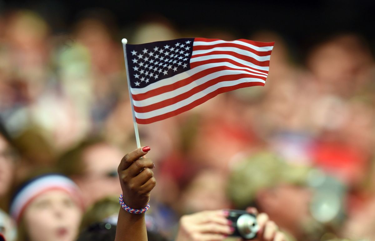A fan waves a flag before the start of the Group D match of the 2015 FIFA Women's World Cup between USA and Australia at the Winnipeg Stadium on June 8, 2015, in Winnipeg, Manitoba. AFP PHOTO/JEWEL SAMAD        (Photo credit should read JEWEL SAMAD/AFP/Getty Images)