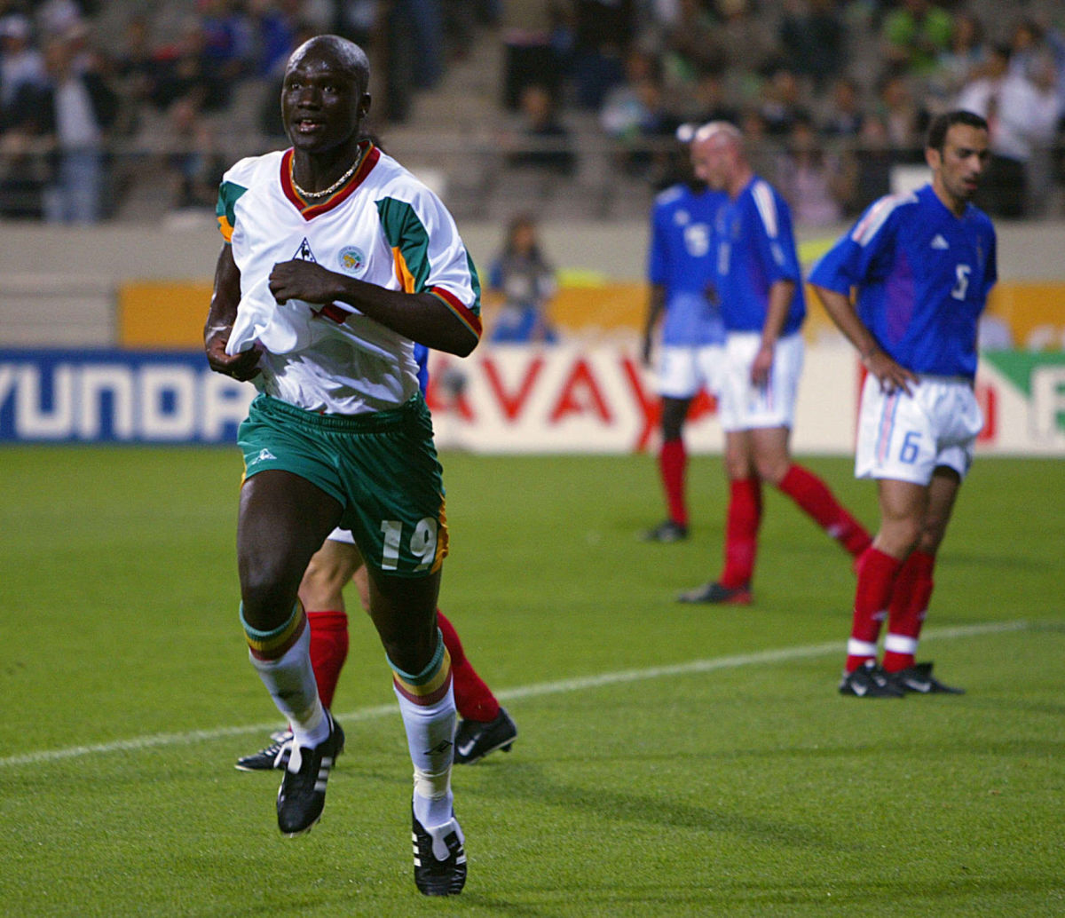SEOUL, REPUBLIC OF KOREA:  Senegalese midfielder Pape Bouba Diop (L) celebrates after scoring the first goal of the 2002 FIFA World Cup Korea/Japan in Seoul, 31 May 2002.  Senegal jumped out to a 1-0 lead over defending world champions France in their opening Group A match.      AFP PHOTO/Patrick HERTZOG (Photo credit should read PATRICK HERTZOG/AFP/Getty Images)