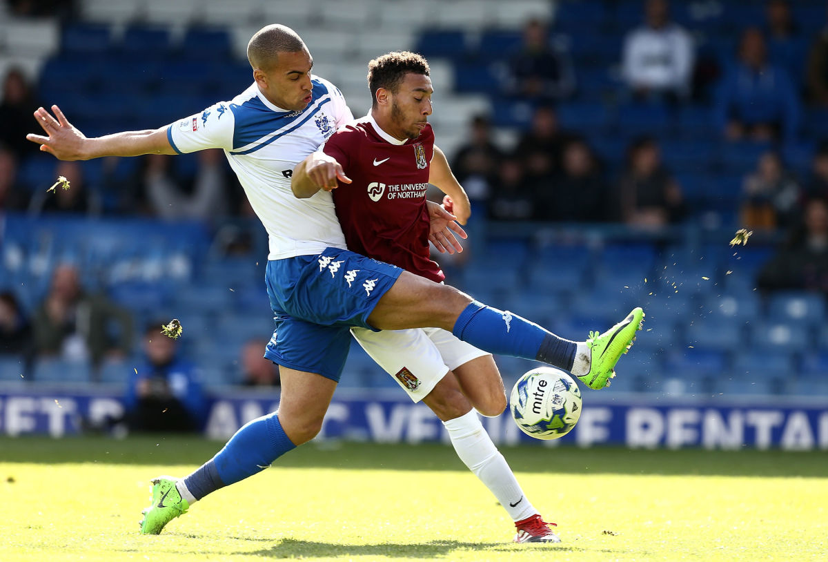 BURY, ENGLAND - APRIL 22:  Keshi Anderson of Northampton Town attempts to play the ball under pressure from James Vaughan of Bury during the Sky Bet League One match between Bury and Northampton Town at Gigg Lane on April 22, 2017 in Bury, England.  (Photo by Pete Norton/Getty Images)