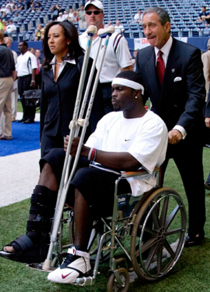Blank wheels an injured Michael Vick onto the field before the 2003 season-opener.