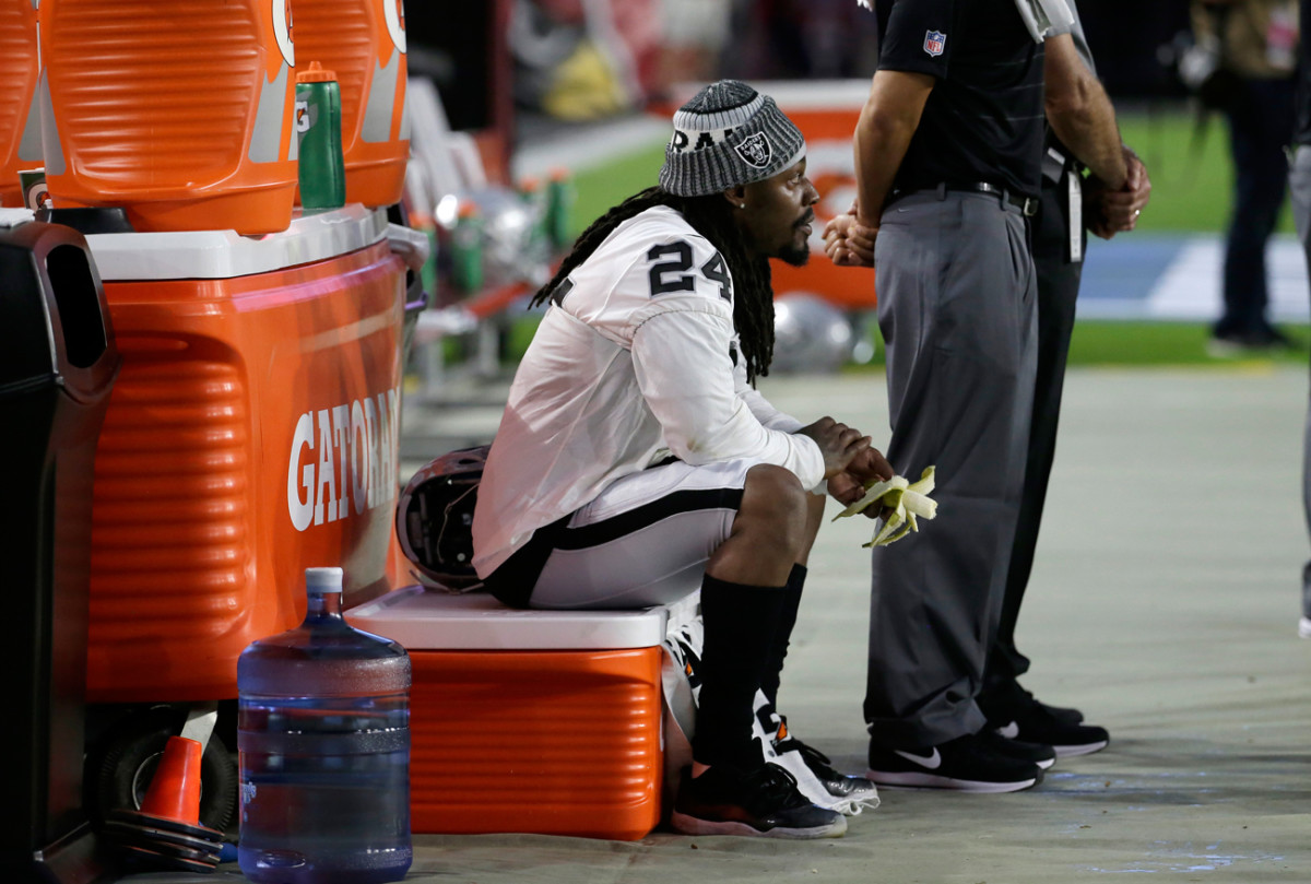 Raiders running back Marshawn Lynch sat and ate a banana during the national anthem before the Oakland-Arizona preseason game on Saturday.