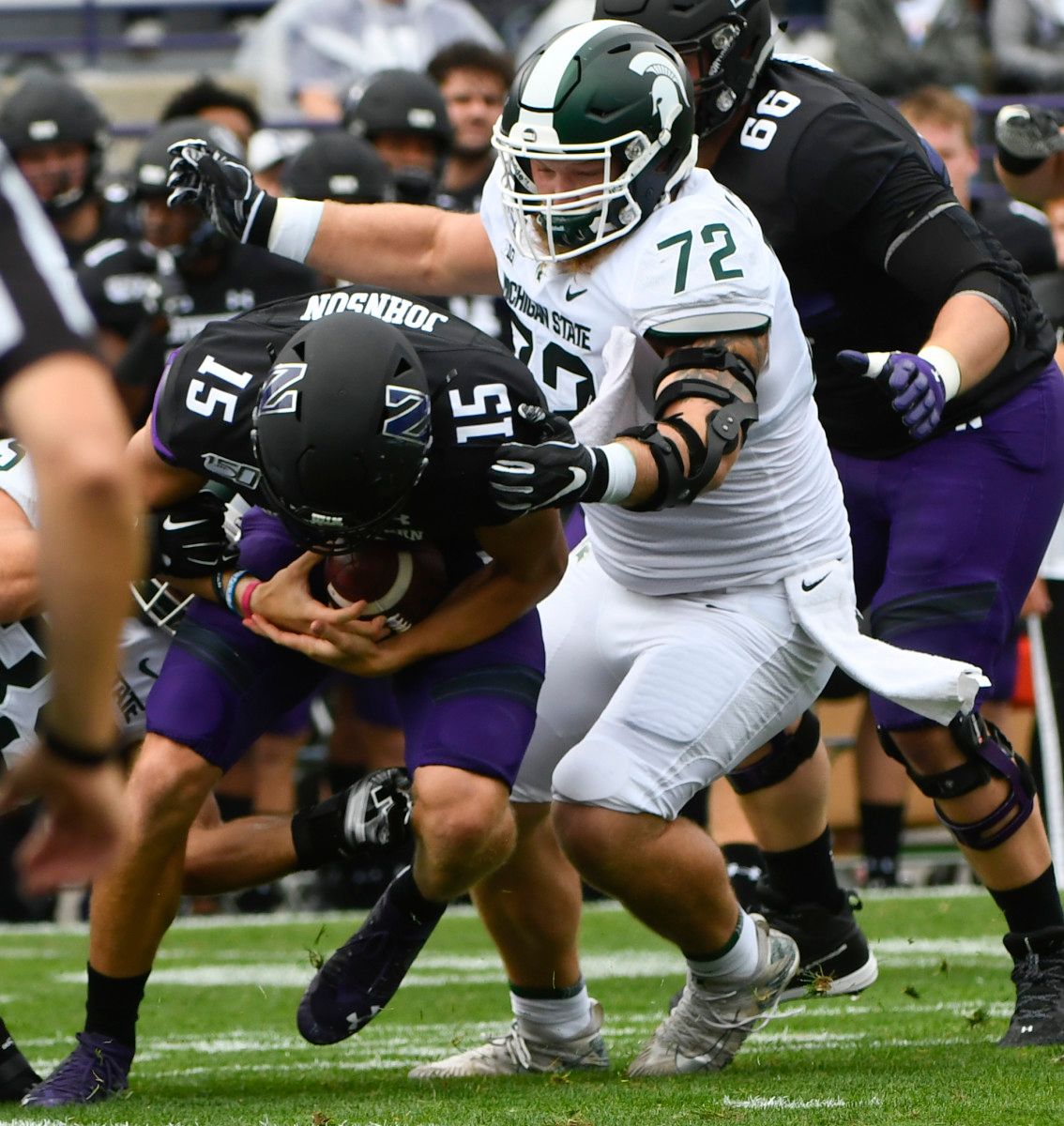 Michigan State defensive tackle Mike Panasiuk (72) sacks Northwestern quarterback Hunter Johnson (15) during the first half at Ryan Field.