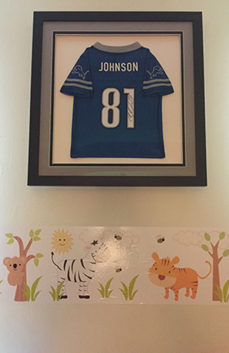 The autographed Calvin Johnson jersey now hangs in Alberta's sons' room. 