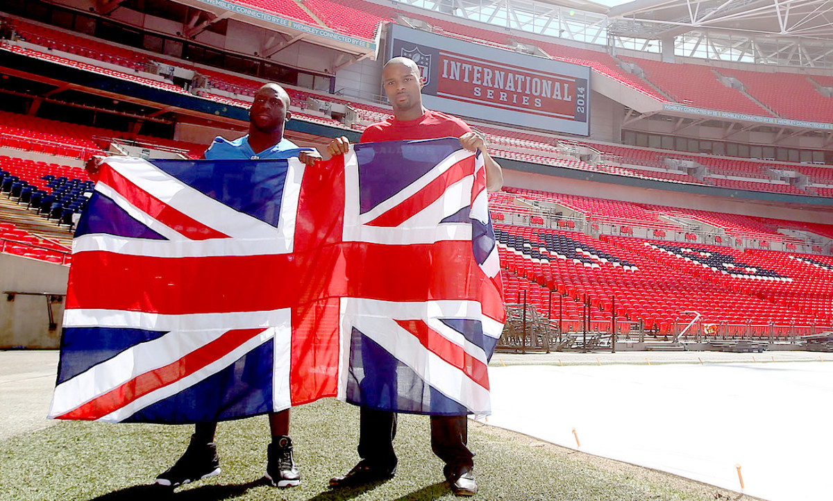 Umenyiora (in red, with Stephen Tulloch) played twice at Wembley, for the Giants and Falcons, and now works with NFL UK.