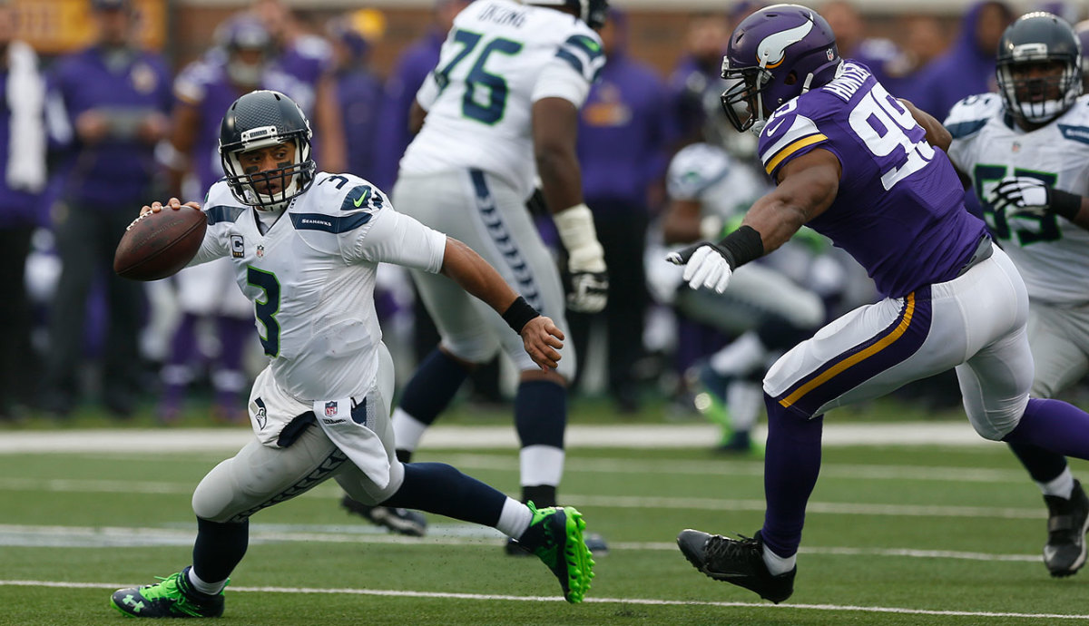 The Seahawks-Vikings wild-card game will be a rematch of their early December meeting. Russell Wilson scored four TDs in a 38-7 win.