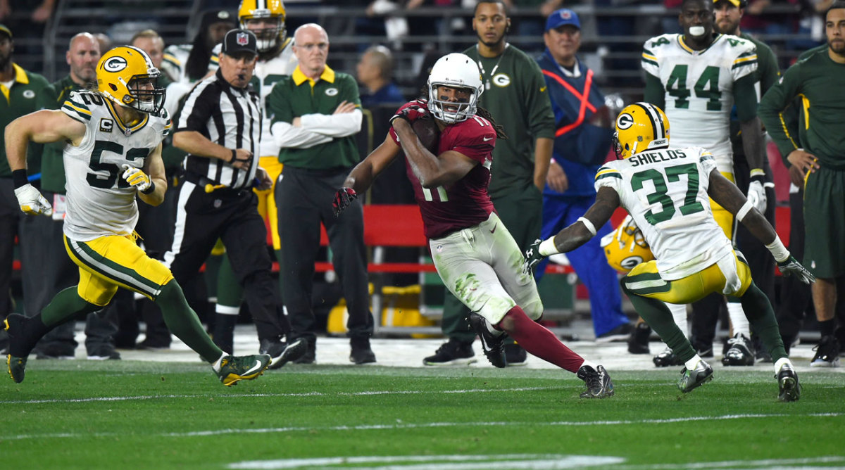 Fitzgerald cuts back during his 75-yard catch-and-run in the Cardinals’ wild win over the Packers.