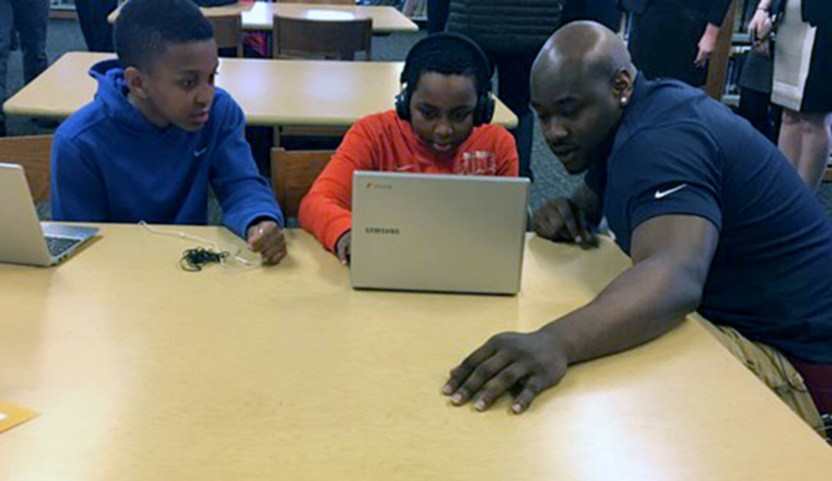 In happier times (earlier on Thursday), Laremy Tunsil visited with Chicago schoolchildren.