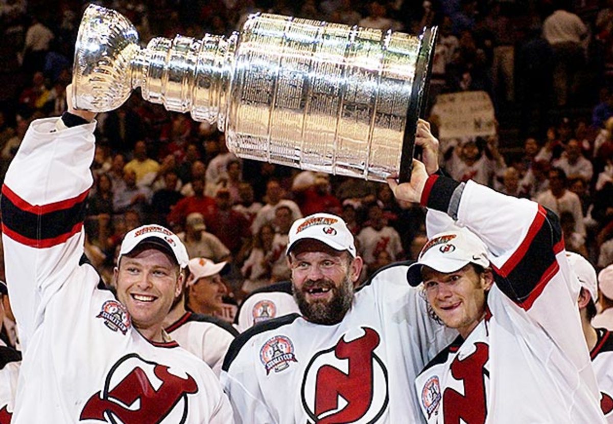 Brodeur (left) with Ken Daneyko and Patrik Elias after defeating the Mighty Ducks in the 2003 Stanley Cup