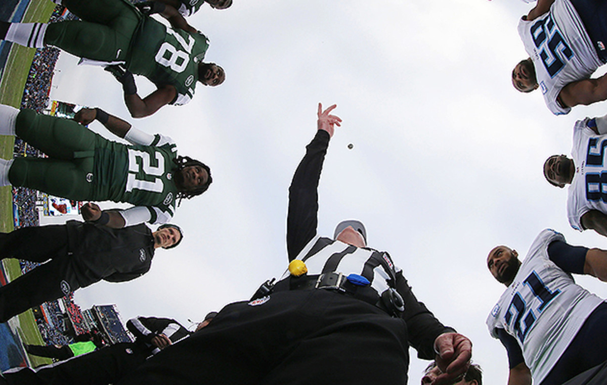 John Parry flips the coin before a Jets-Titans game on Dec. 14, 2014.