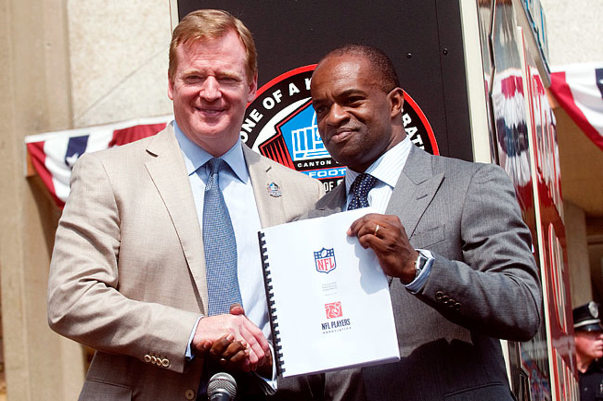Roger Goodell (l.) DeMaurice Smith shook hands after signing the new CBA on Aug. 5, 2011.