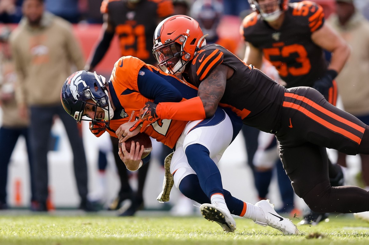 Denver Broncos quarterback Brandon Allen (2) is sacked by Cleveland Browns linebacker Mack Wilson (51) in the first quarter at Empower Field at Mile High.