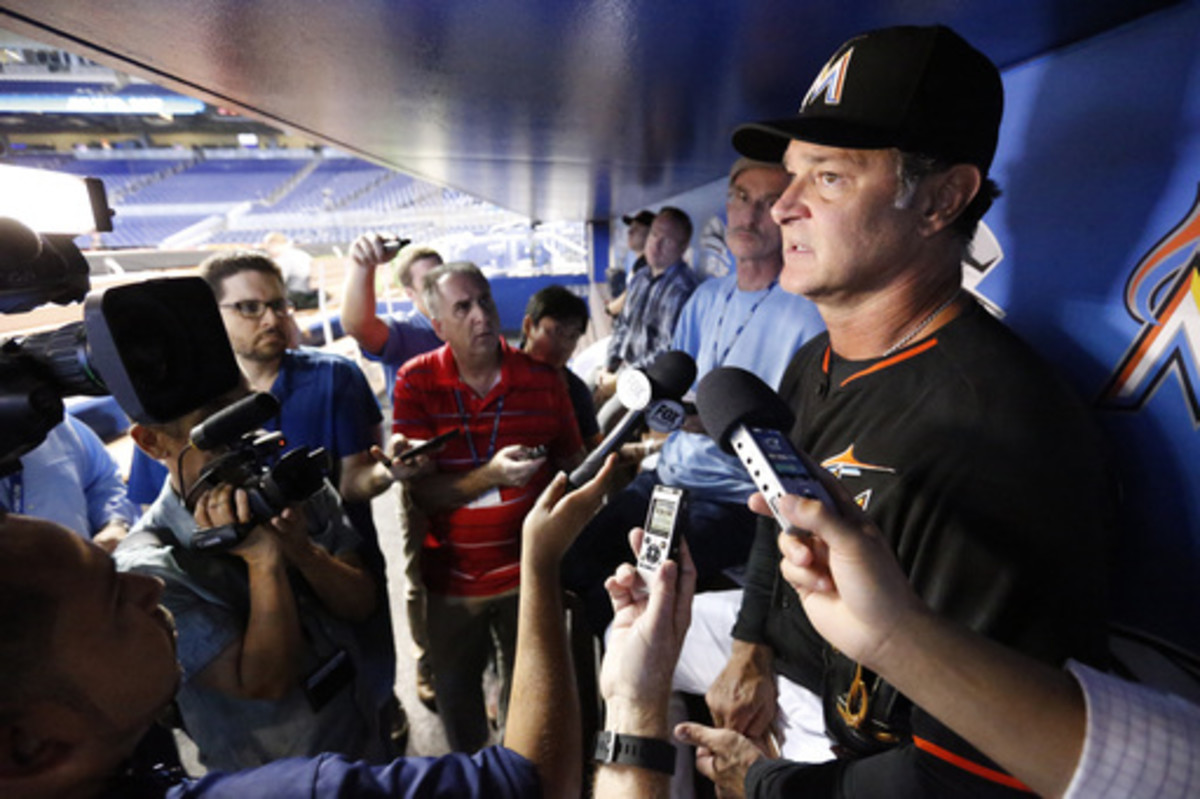 Miami Marlins manager Don Mattingly, right, talks to members of the media before the start of a baseball game against the Chicago White Sox, Saturday, Aug. 13, 2016, in Miami. Mattingly says Marlins officials haven't discussed trying to coax Alex Rodrigue
