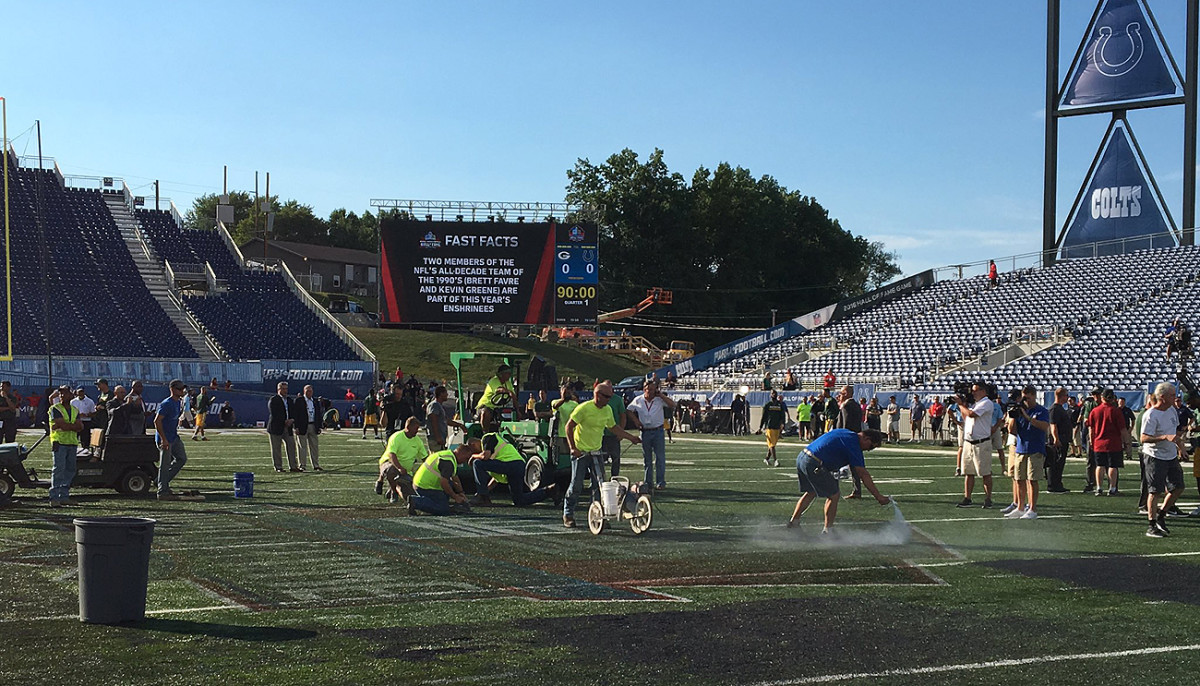 Field maintenance workers scrambled to get the turf ready for Sunday night’s game, which ultimately was cancelled due to unsafe playing conditions.