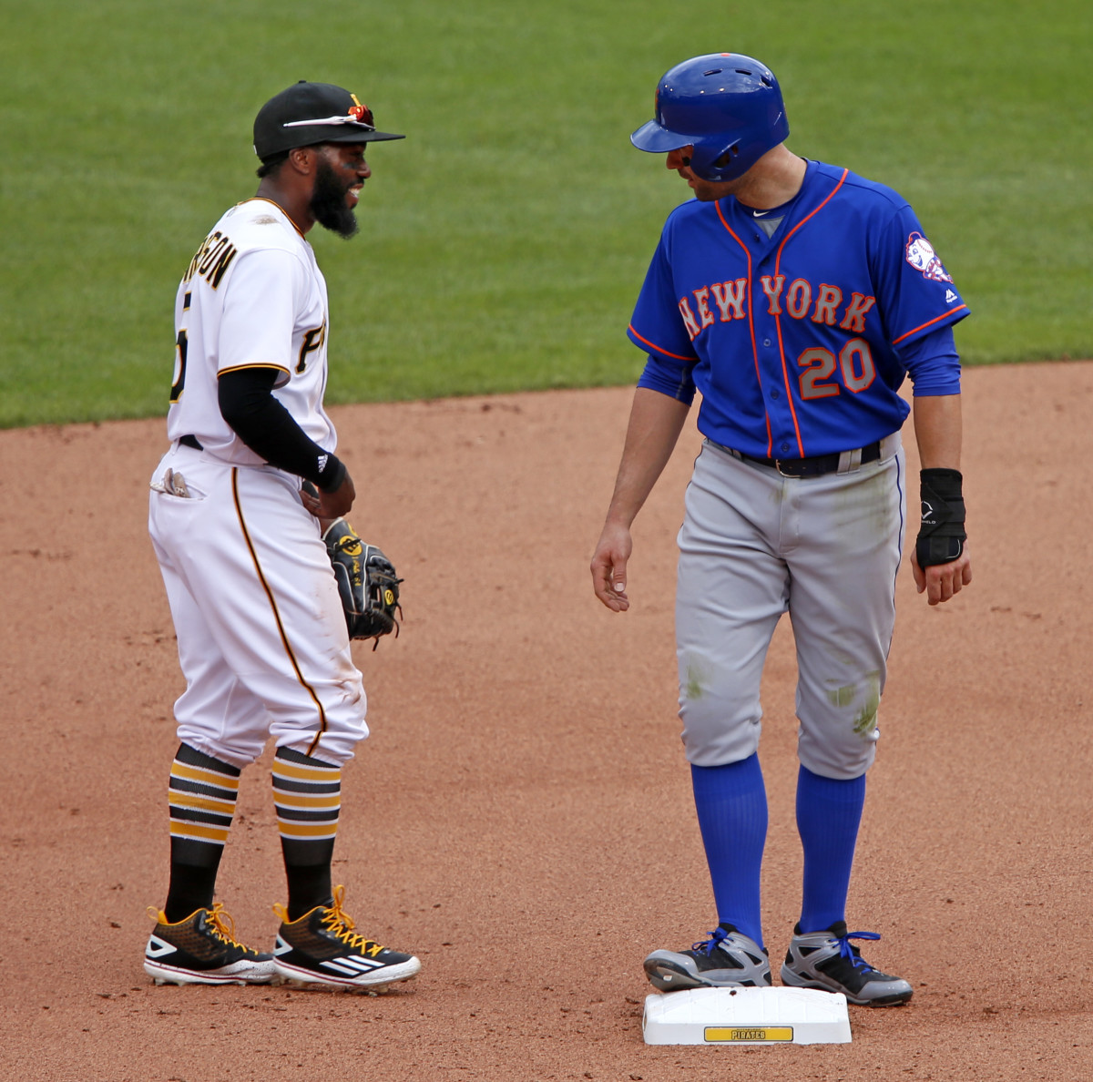 Former teammates New York Mets second baseman Neil Walker (20) and Pittsburgh Pirates second baseman Josh Harrison visit during the fourth inning of a baseball game in Pittsburgh, Tuesday, June 7, 2016. (AP Photo/Gene J. Puskar)
