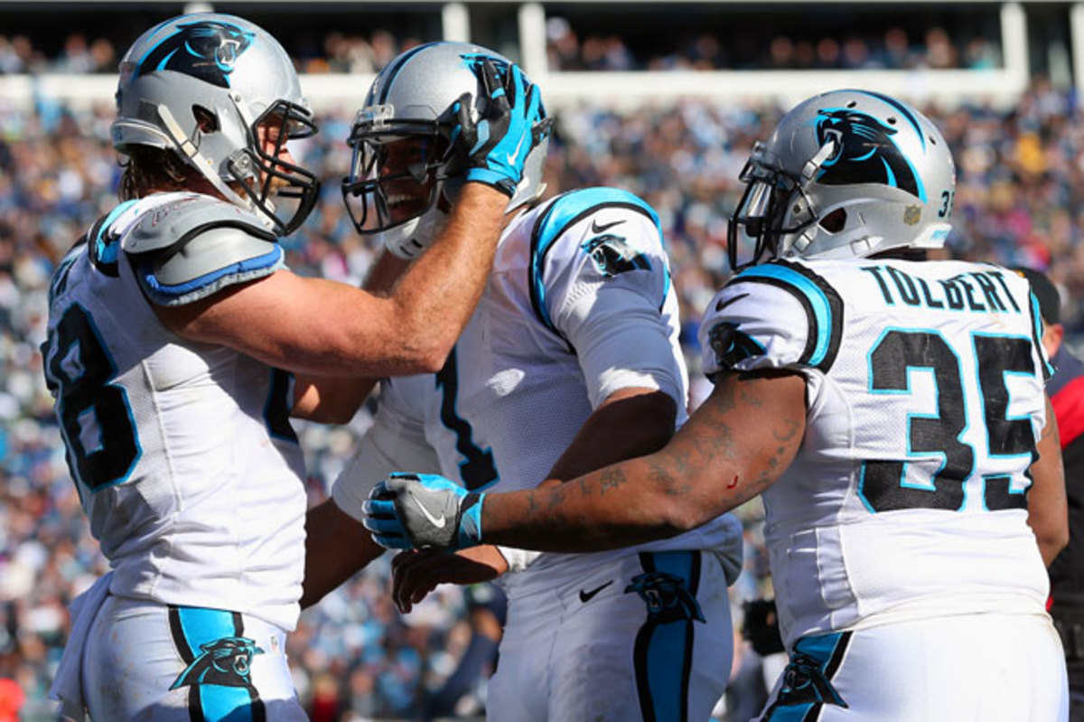 Greg Olsen (l.), Cam Newton and Mike Tolbert celebrate after a touchdown against the Seahawks in the divisional round.