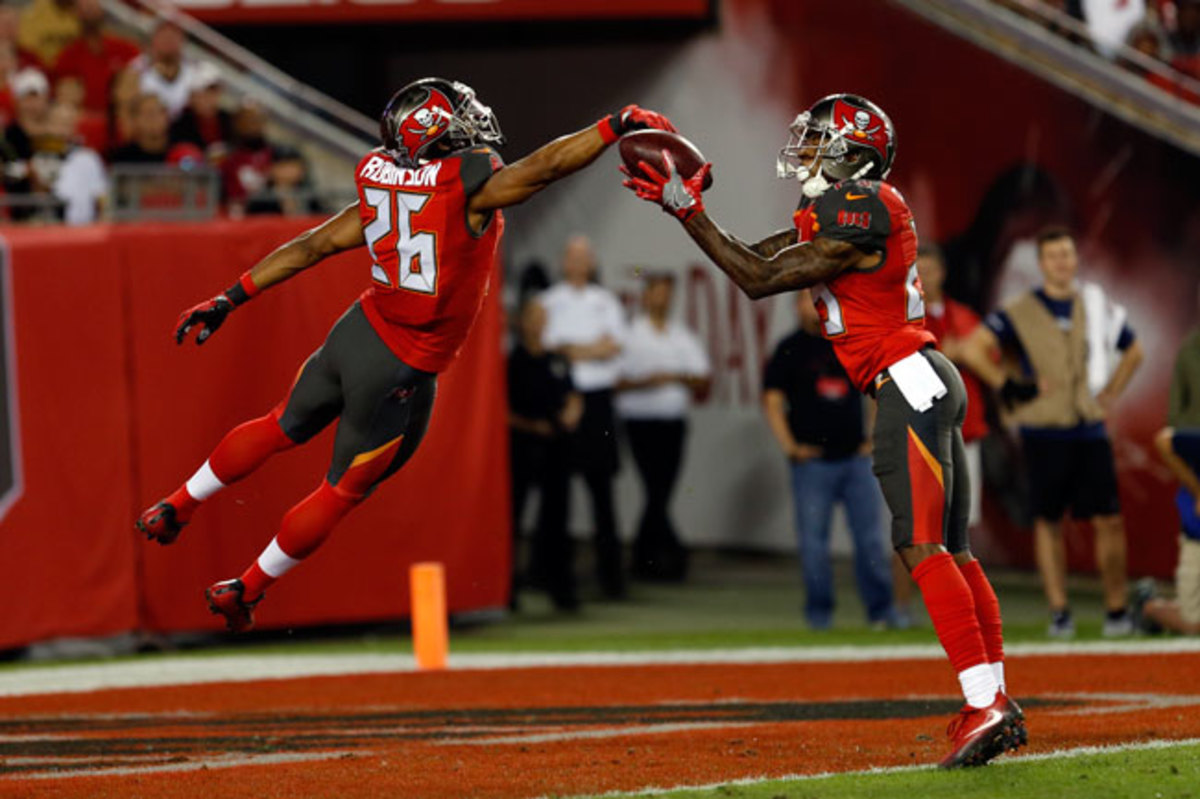 The Buccaneers’ Ryan Smith (29) and Josh Robinson (26) keep the ball out of the end zone on a punt while Alan Cross (not pictured) downs it at the 1-yard line against the Saints Dec. 11.