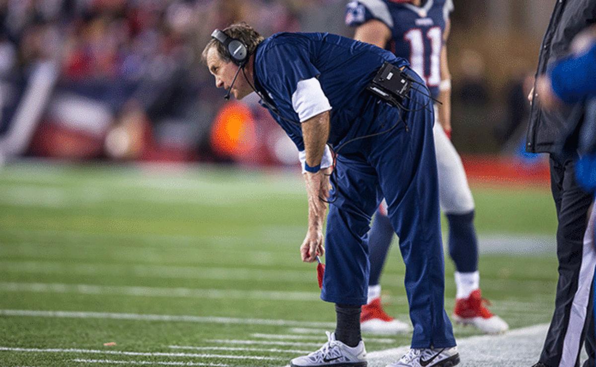Patriots coach Bill Belichick removes the challenge flag from his sock during last season's divisional playoff game against the Chiefs.