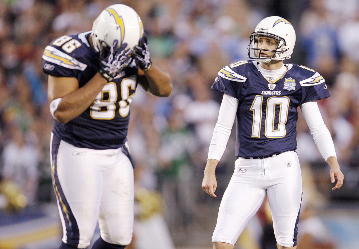 Kaeding and teammate Brandon Manumaleuna moments after the kicker’s third field goal attempt sailed wide right during San Diego’s 2009 playoff loss to the Jets.