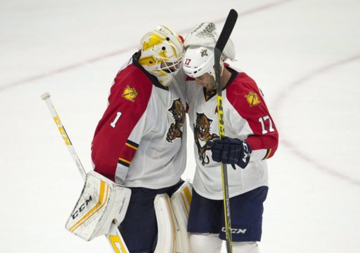 Florida Panthers goalie Roberto Luongo celebrates with center Derek MacKenzie after an NHL hockey game against the Ottawa Senators on Thursday, Jan. 7, 2015, in Ottawa, Ontario. (Adrian Wyld/The Canadian Press via AP)