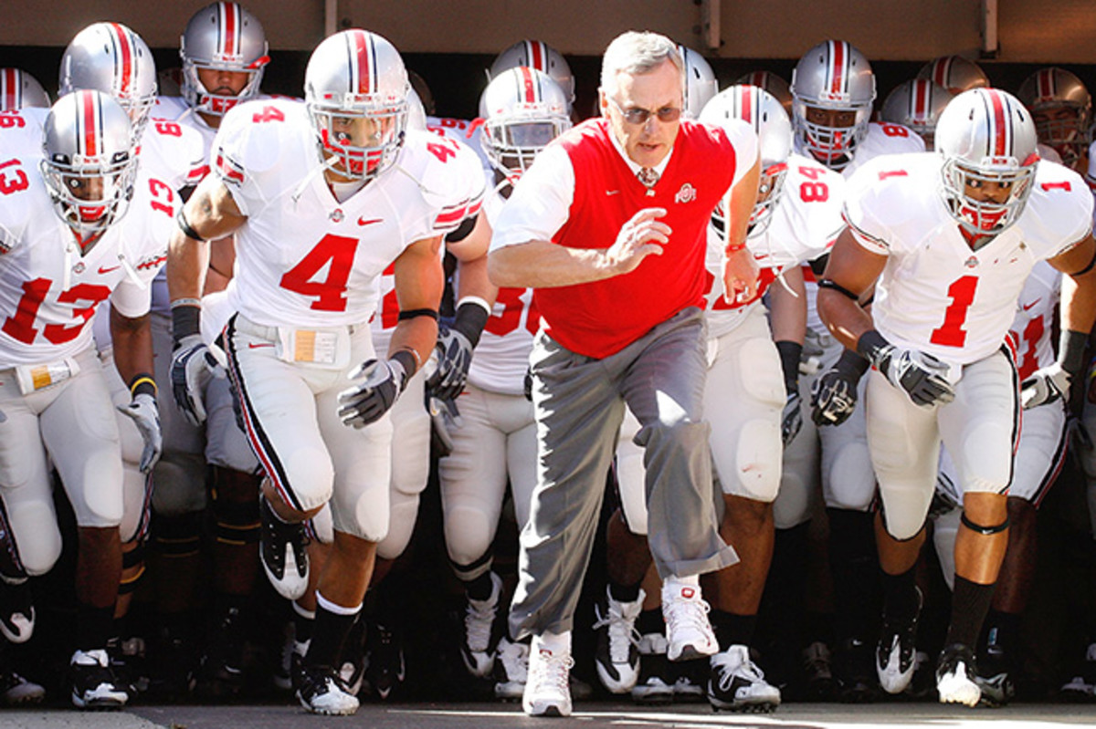 Tressel and Kurt Coleman (No. 4) led Ohio State out of the tunnel before a 2009 game against Akron