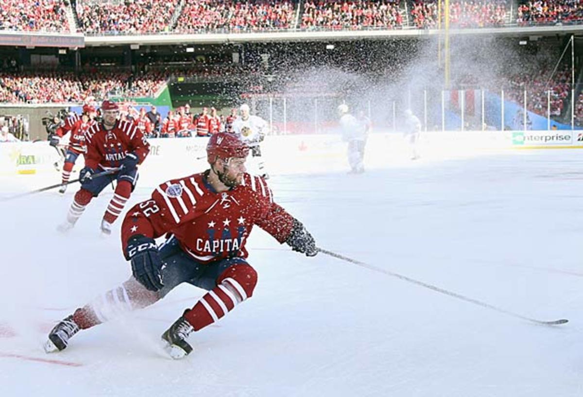 Mike Green of the Capitals sends a shower of chips into the air. Ice quality has been good.