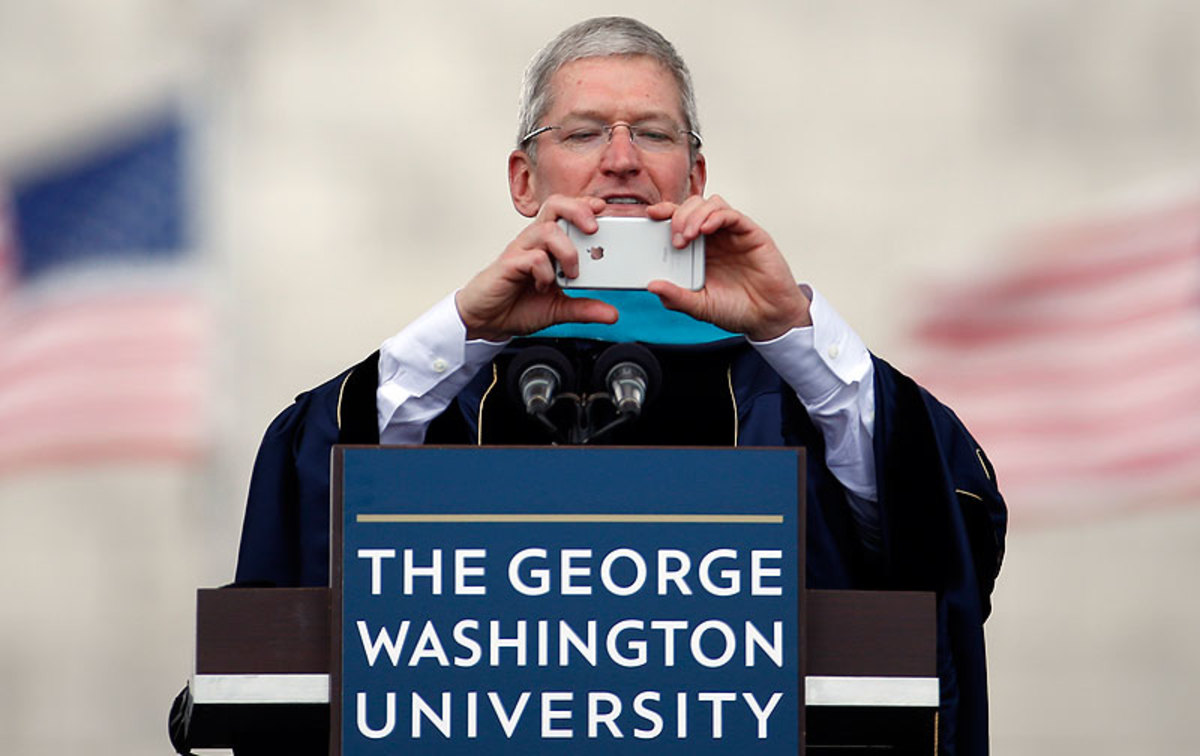 Apple CEO Tim Cook used an iPhone to snap a picture during his commencement speech at George Washington. (Alex Brandon/AP)