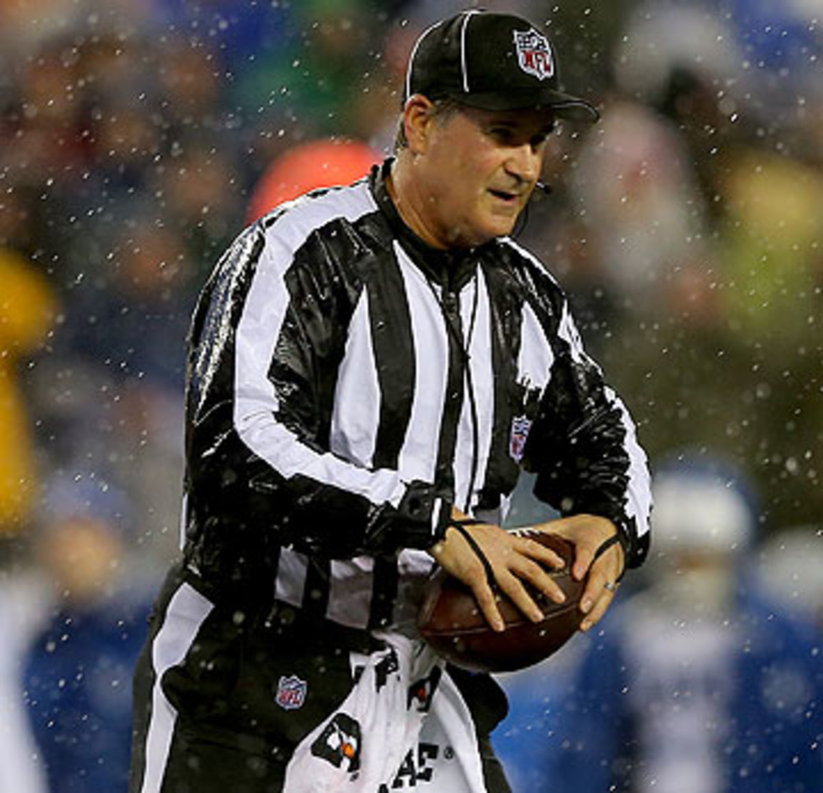 Inclement conditions can adjust the amount of footballs the refs use during games. (Elsa/Getty Images)