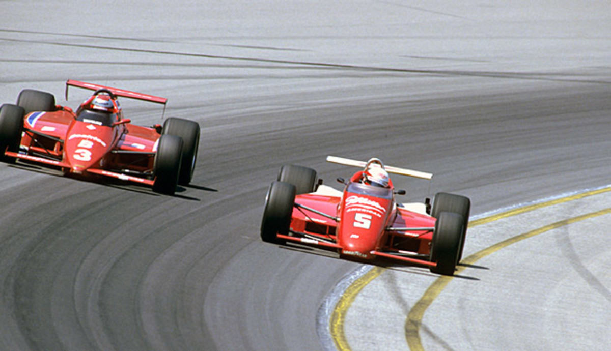 Danny Sullivan (right) passes Mario Andretti en route to the checkers.
