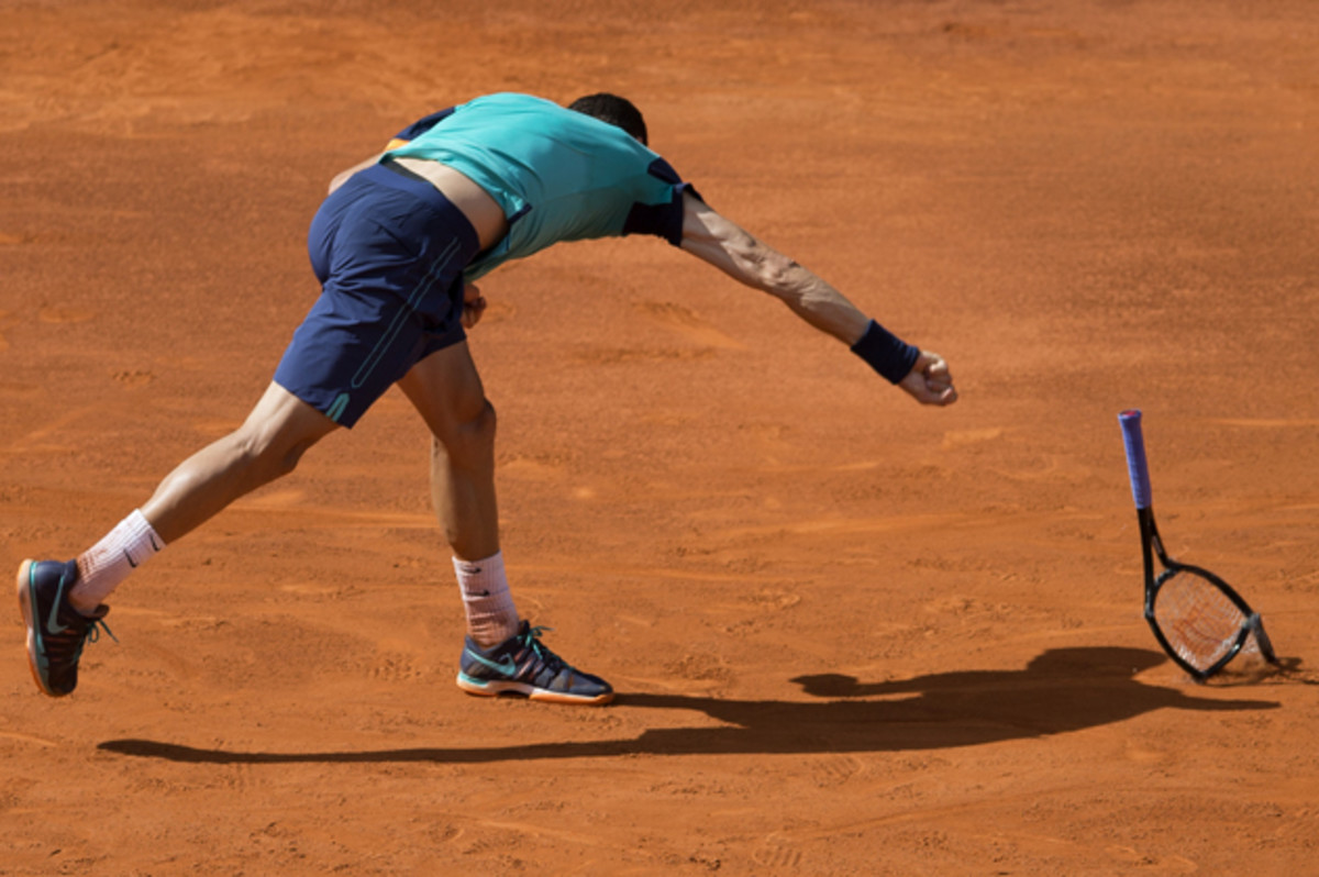 Grigor Dimitrov smashes his racket during his match against Rafael Nadal.