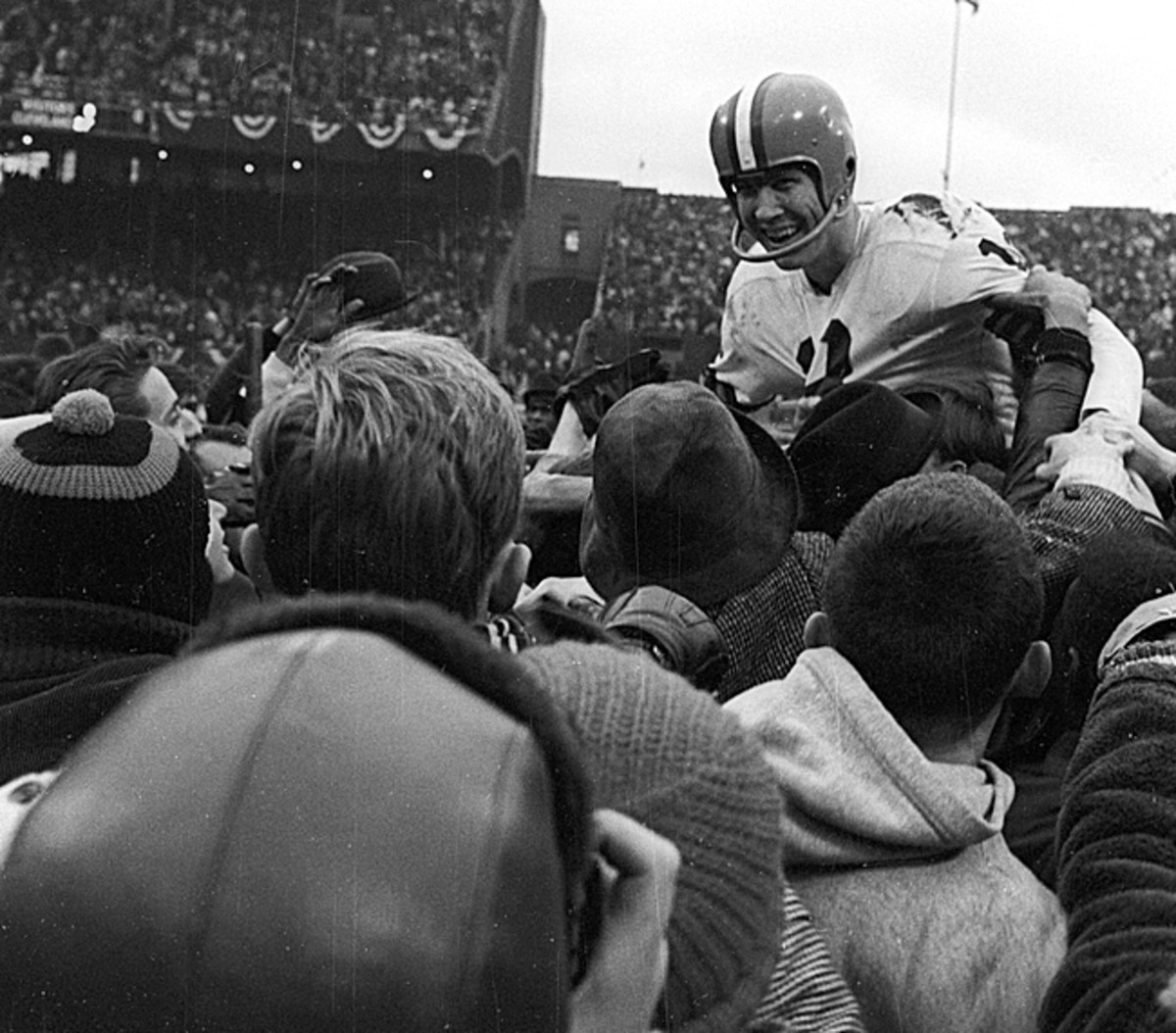 Quarterback Frank Ryan was carried off by fans after leading the Browns to victory in the 1964 NFL title game. It was the city's last championship. (James Drake/Sports Illustrated)