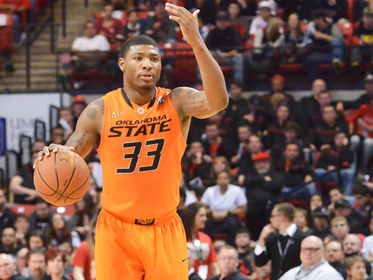 Marcus Smart will sit three games after he shoved a fan in Oklahoma State's loss to Texas Tech. (John Weast/Getty Images)