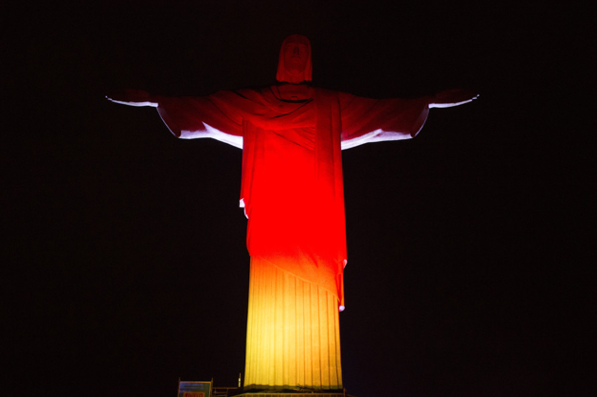 The Christ the Redeemer statue in Rio de Janeiro is illuminated in Germany's colors on the eve of the World Cup final. 