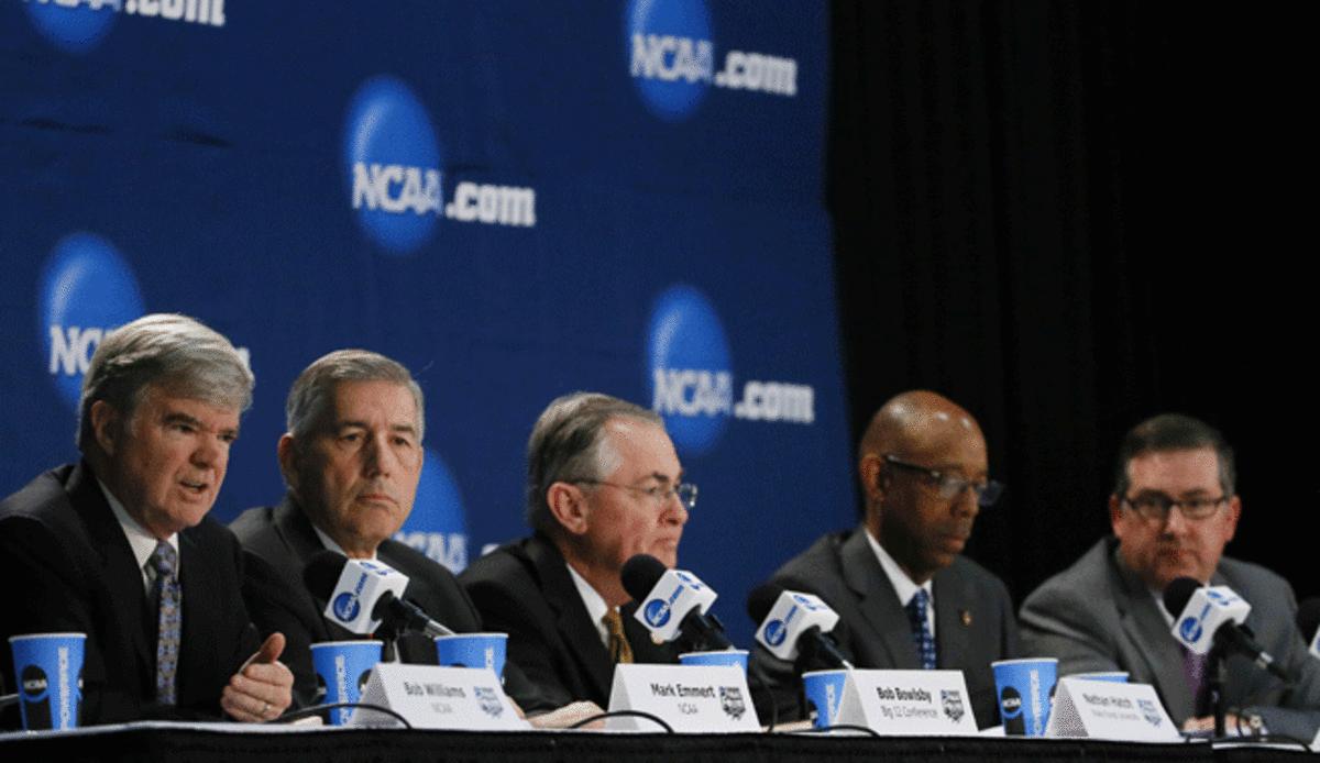 NCAA president Mark Emmert (far left) delivered a typically uninspiring message to the media Sunday.