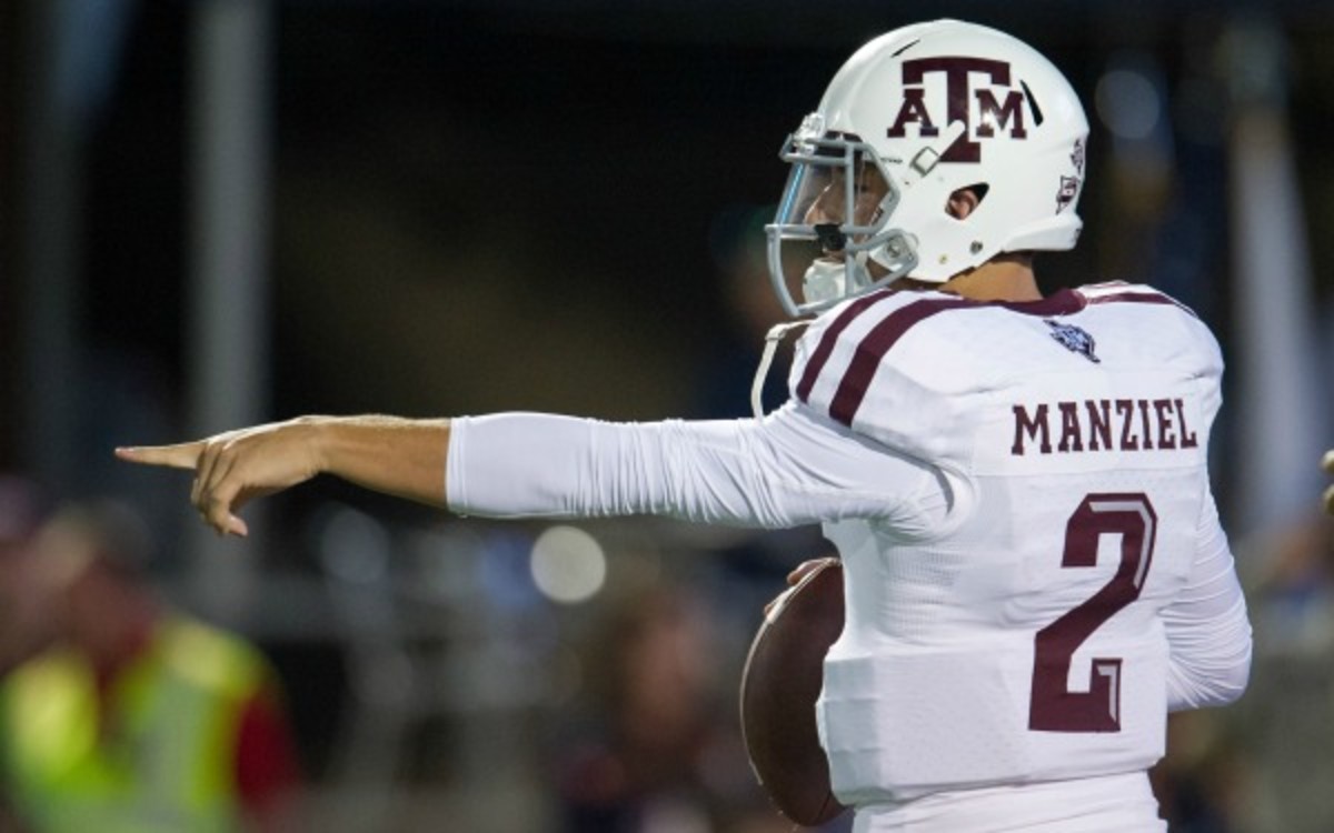 Johnny Manziel injured his right shoulder Saturday and is being evaluated by trainers. (Michael Chang/Getty Images)