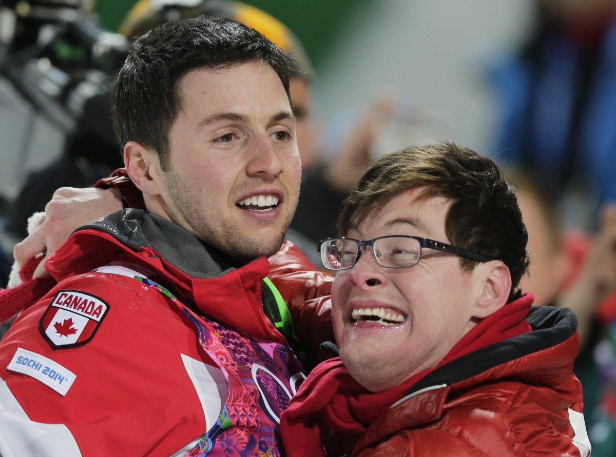 Canada's Alex Bilodeau, left, celebrates with his brother Frederic after winning the gold medal in the men's moguls final on Monday.