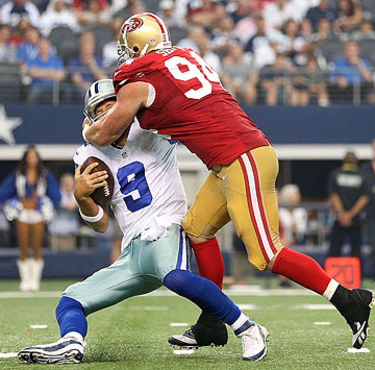 Tony Romo was sacked three times Sunday, twice by Justin Smith. (Christian Petersen/Getty Images)