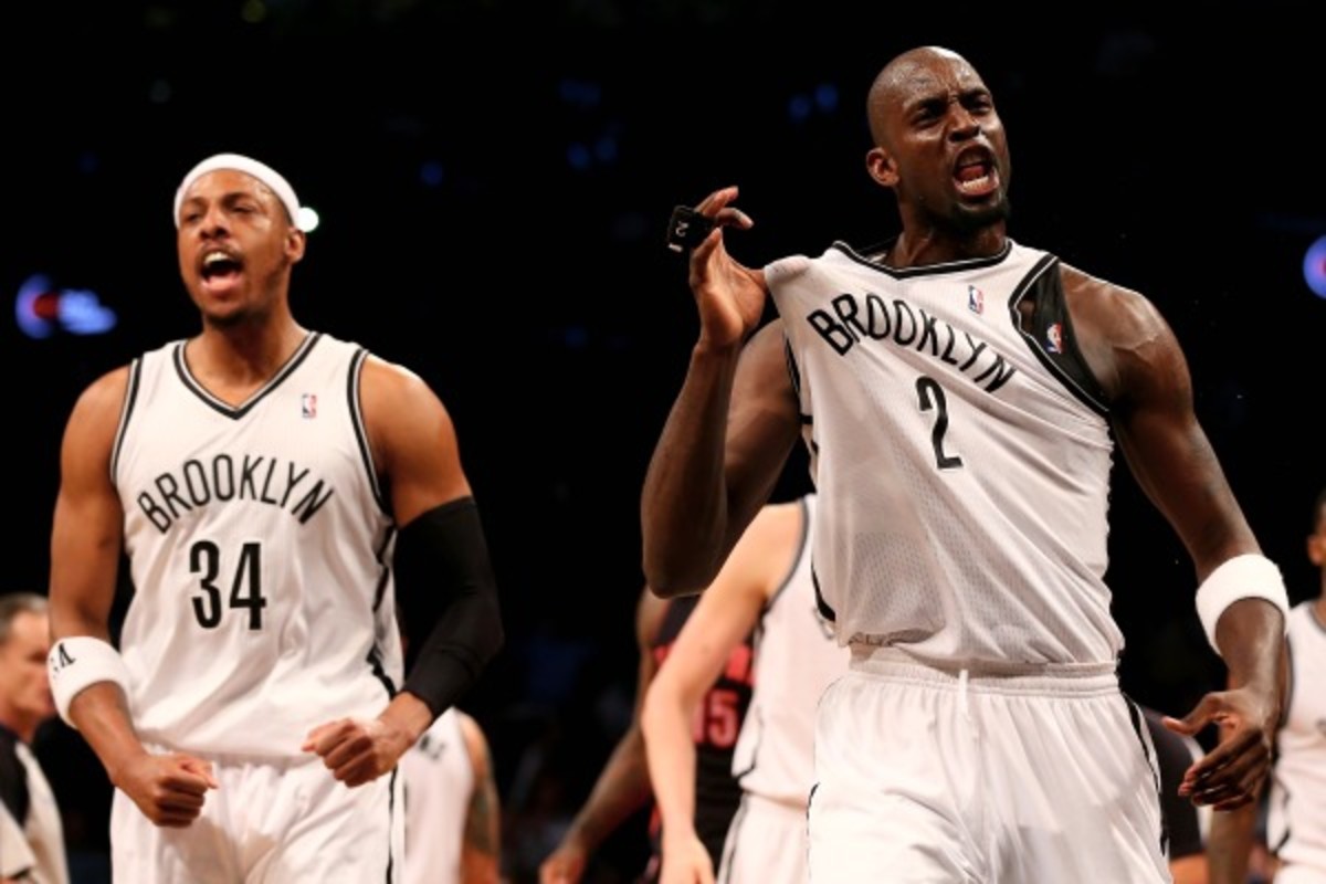 Kevin Garnett (right) and Paul Pierce (left) were providing noise at the Barclays Center on Friday. (Elsa/Getty Images)