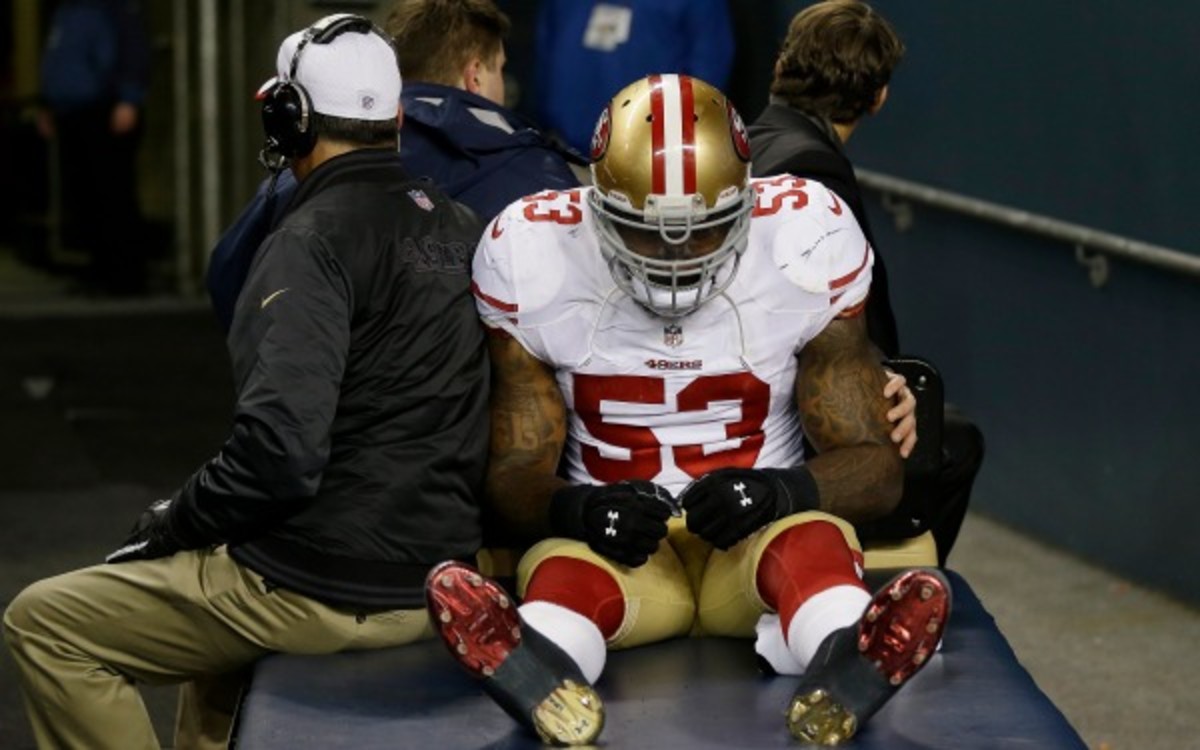 49ers linebacker NaVorro Bowman is carted off the field after injuring his knee against the Seahawks. (AP Photo)