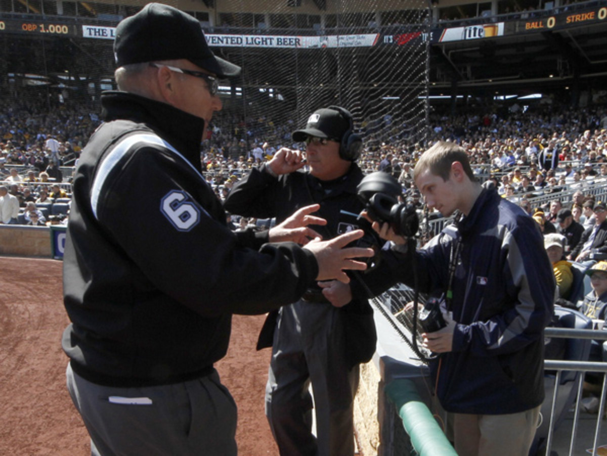 Bob Davidson (left) and the umpire crew review a play during Monday's game. (Gene Puskar/AP)