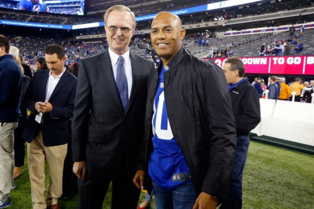 John Mara (left) poses with a guy who knows a little about the postseason. (Jim McIsaac/Getty Images)