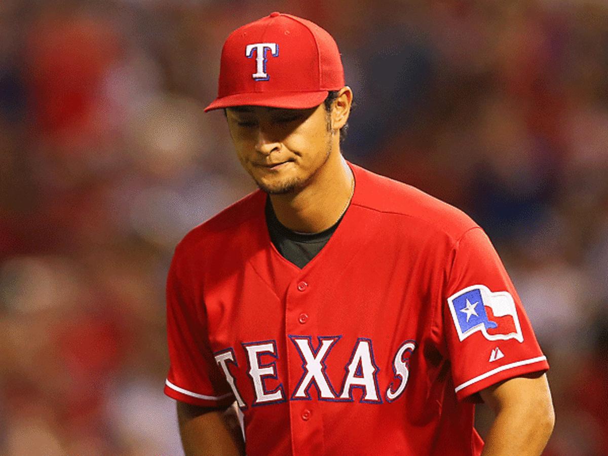 Yu Darvish reacts after a seventh-inning error ended his perfect game bid vs. Boston. (Ronald Martinez/Getty Images)